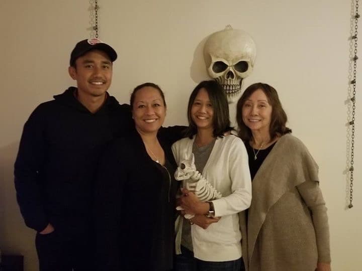 My mom, my two sisters and me, standing together.